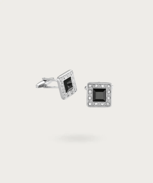 Boutons de manchette en forme de carré argenté avec brillants noirs enchâssés, exprimant une élégance audacieuse et un style contemporain.